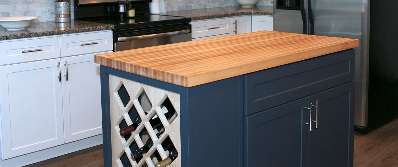 Wood countertops offer a natural aesthetic to your kitchen but still fit in with modern designs. You might also hear wood countertops be called butcher block countertops. Wood can add warmth to your kitchen compared to other materials like granite that can be cold and minimalistic; this comes down to your style preferences. Refinishing a wood countertop is relatively easy with a bit of sanding involved and then applying a finish to the surface.