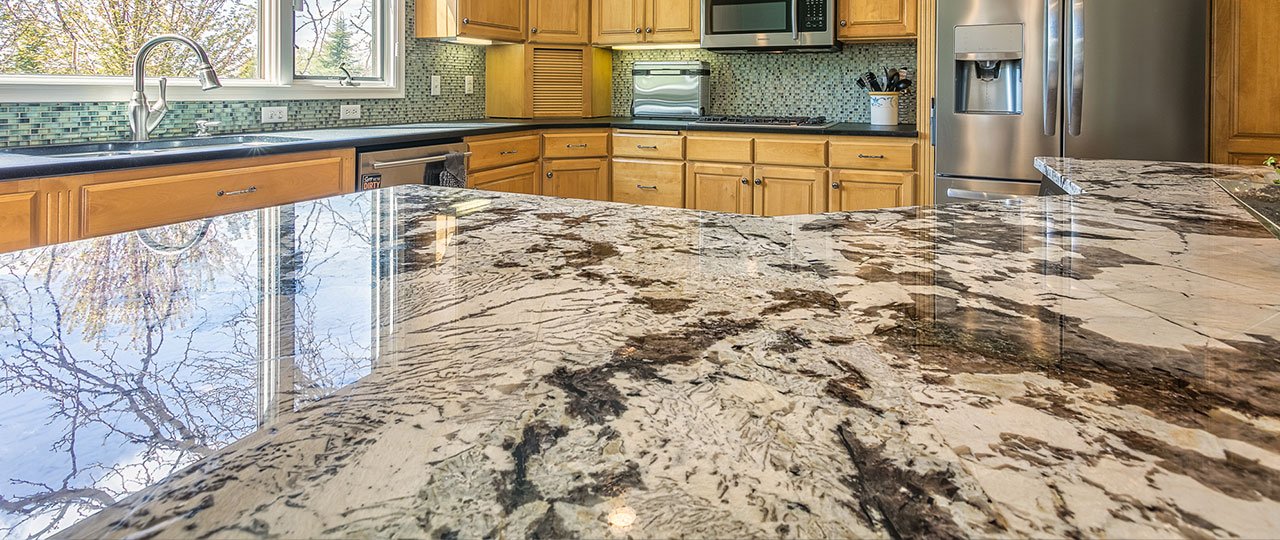 Granite is a natural stone with a smooth, natural look, making it one of the more popular kitchens' choices. It comes in an assortment of shades and patterns. Granite is a higher investment option, and requires consistent care and maintenance.